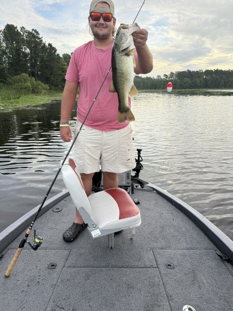 Angler with a largemouth bass in the evening light on the St. Johns River