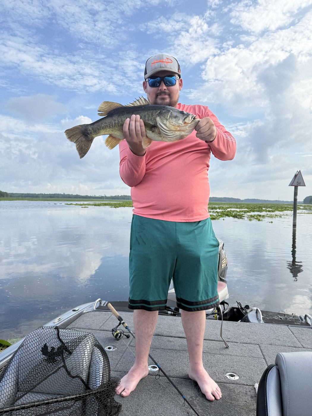 Angler holding a big largemouth bass on open water in Northeast Florida